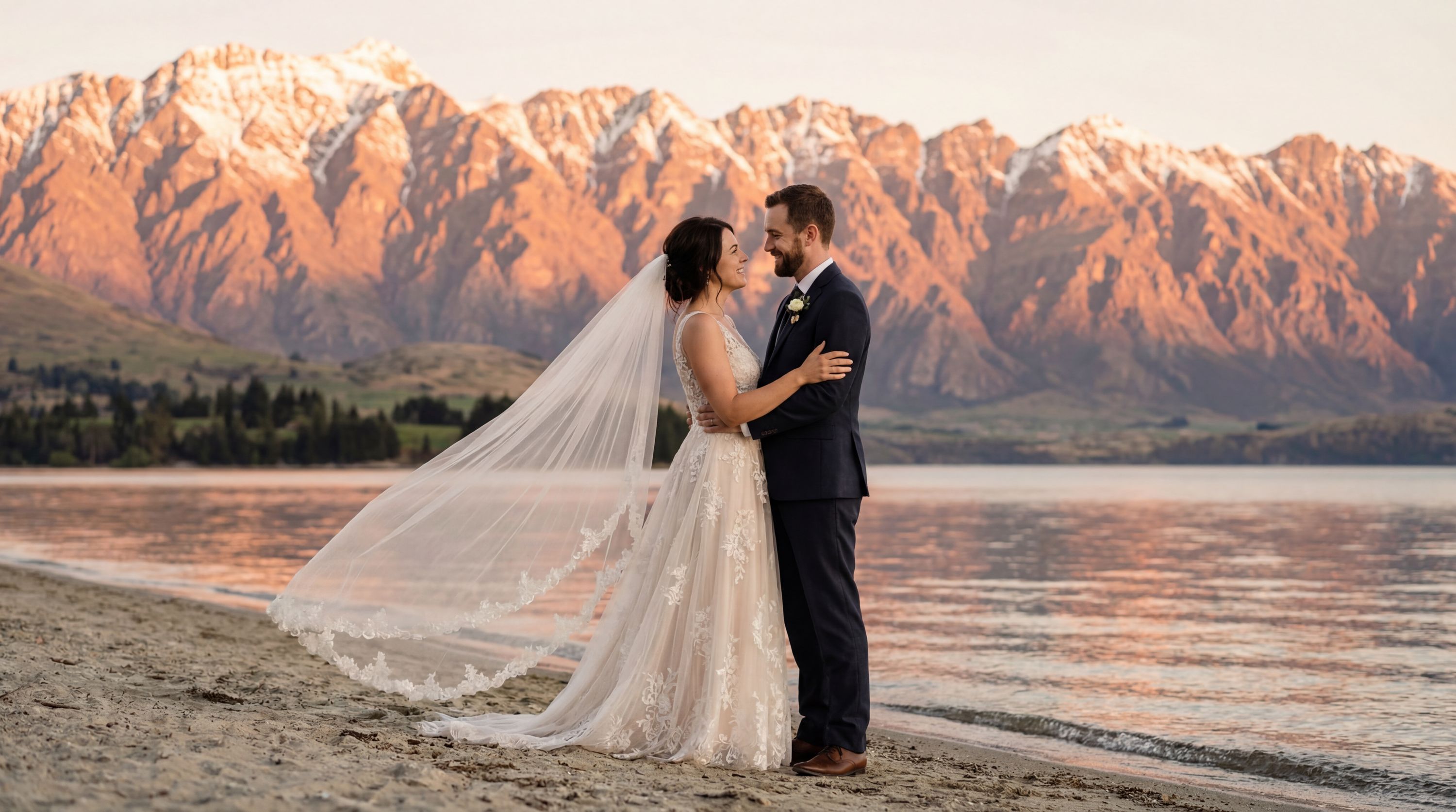 Queenstown wedding photography — couple at Lake Wakatipu with The Remarkables mountain range and turquoise alpine waters